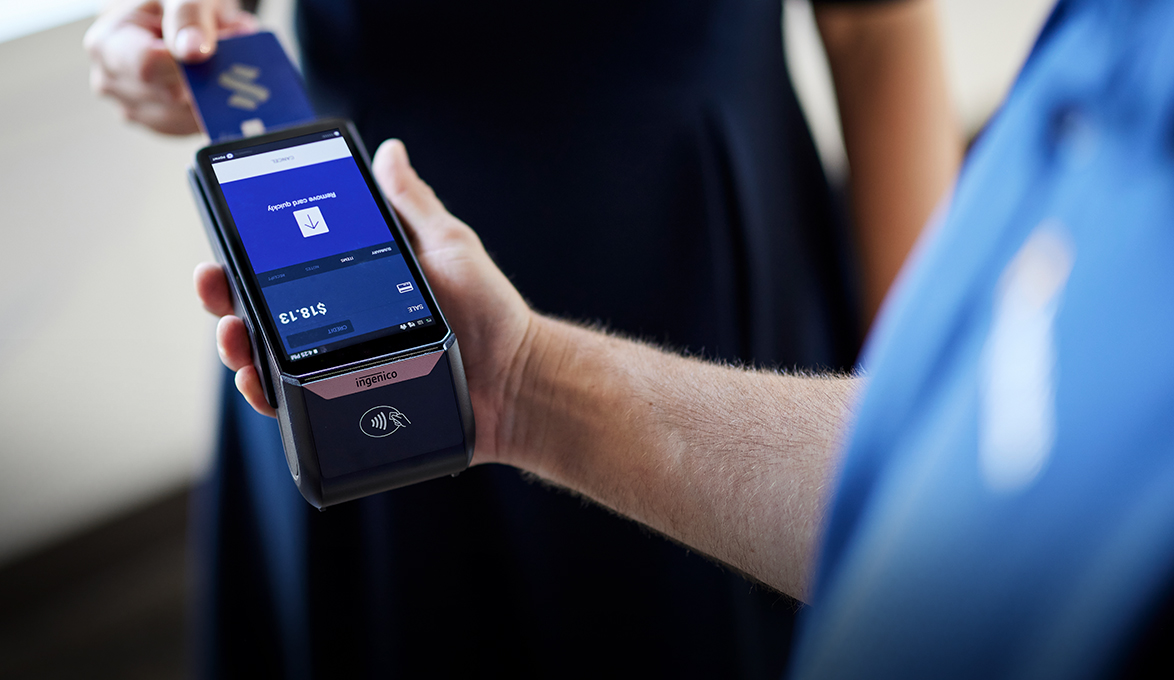 small business owner using merchant terminal payment solution
